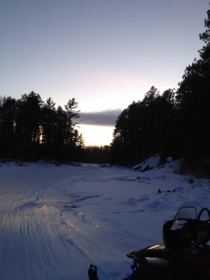 Sunset on river while snowmobiling