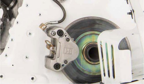 Disk brake is mounted low in the tunnel directly to the front drive shaft.
